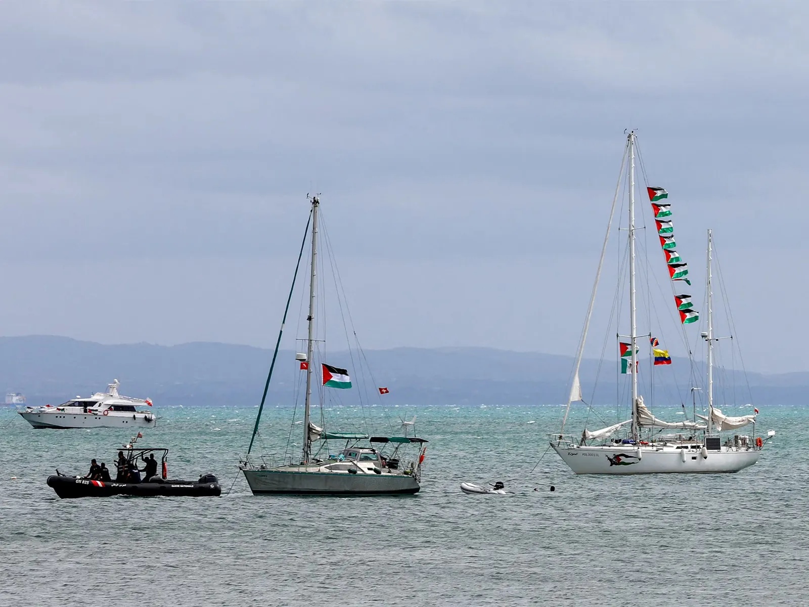 Boats with Palestinian and other flags, which are part of the Global Sumud Flotilla, wait to set sail towards Gaza, with other boats from Tunisia (Photo/Reuters)
