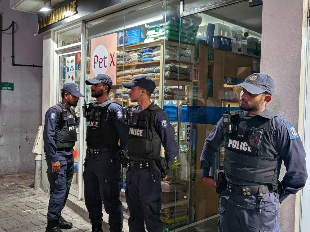 Police officers outside the Adhadhu news office during a raid on Monday night  (Photo/Maldives Journalists Association)
