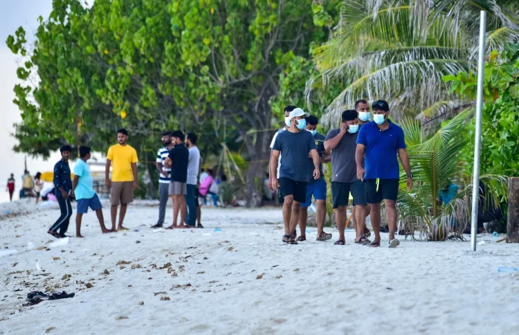 Indian tourists walking along the beach in Hulhumale'
