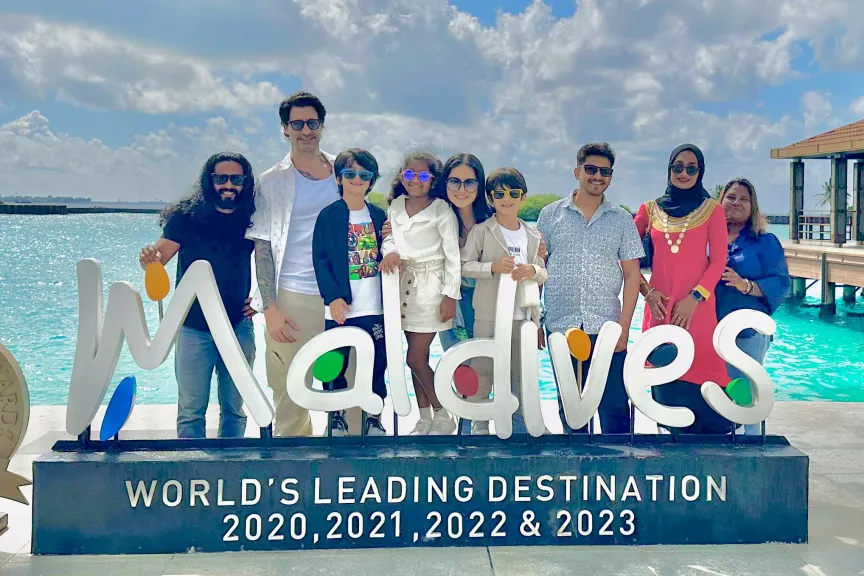 Sunny Leone along with her family, Maldivian influencers near Visit Maldives Logo in Velana International Airport
