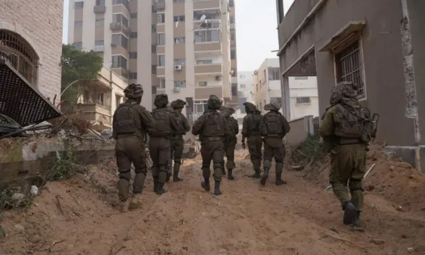 Israeli soldiers walk in the Gaza Strip