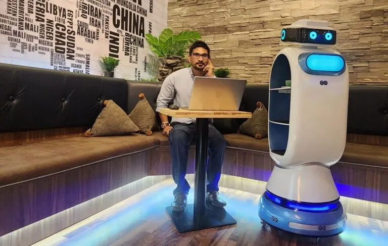 Rafiuddin is next to the robotic waiter of Ocean Bubbles.