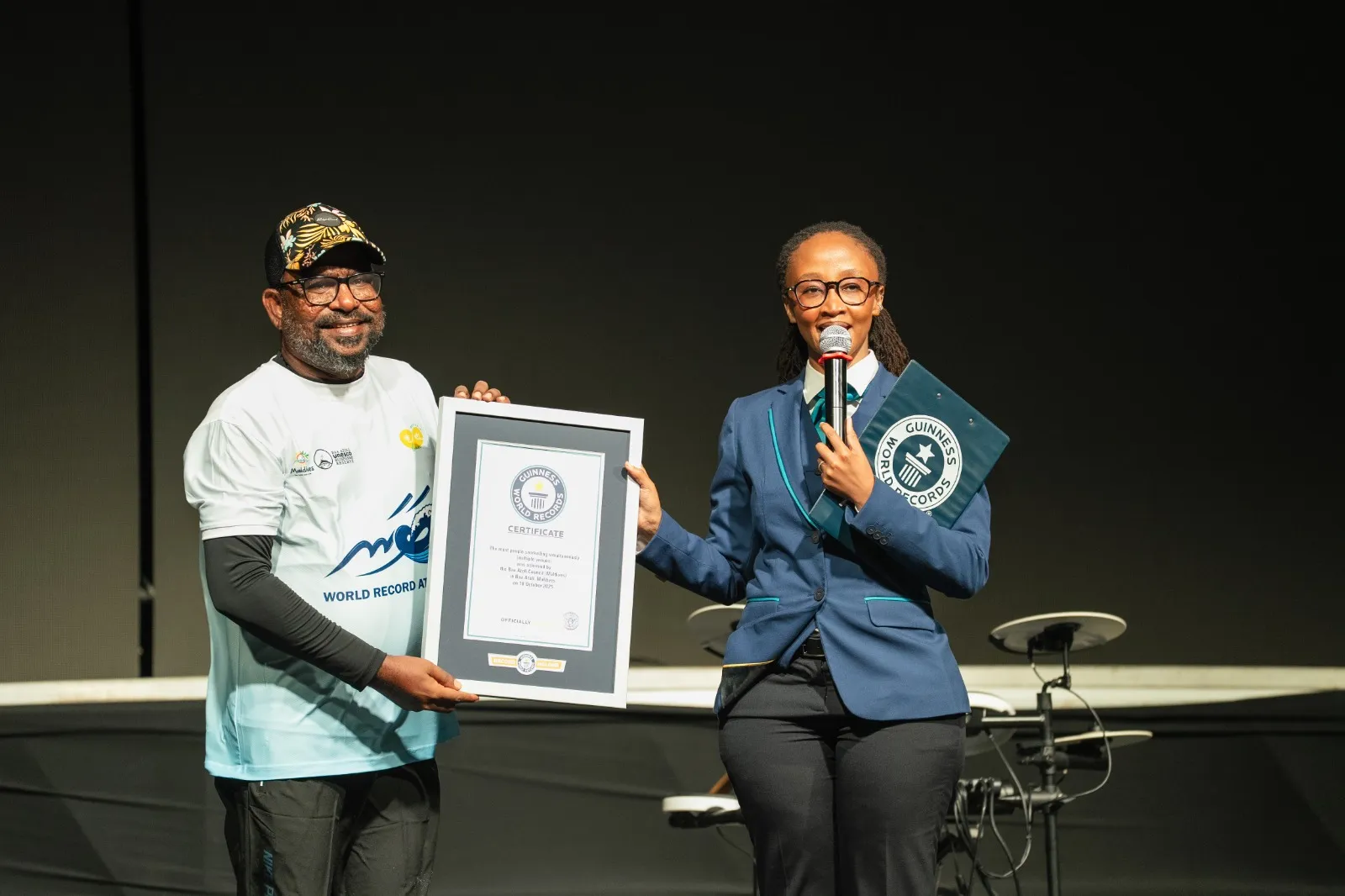 Guinness World Records official adjudicator presenting the certification plaque to the Baa Atoll Council