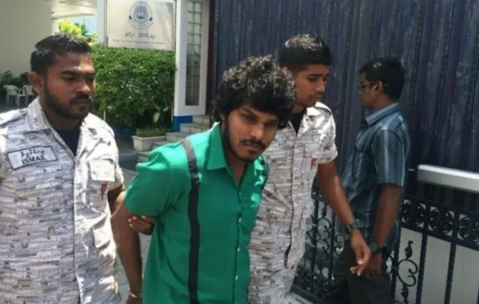 Humaam outside of court in prison attire
