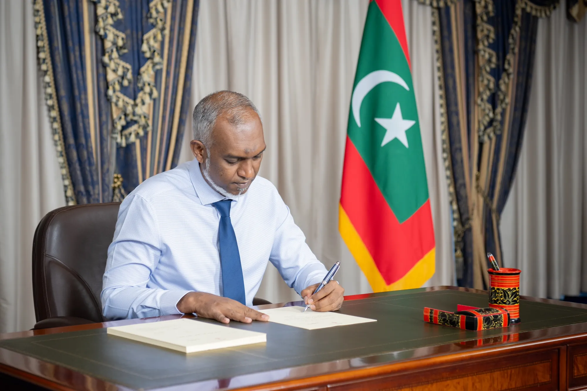 President Dr. Muizzu passing the bill (Photo/President's Office)