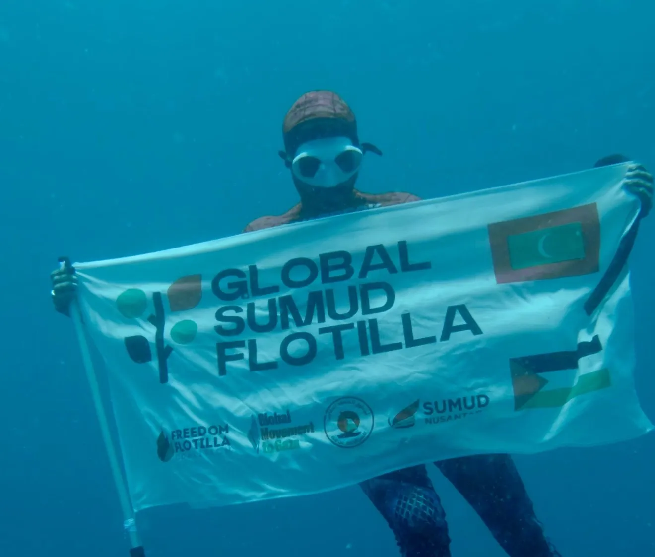 Diver Underwater Waving the Global Sumud Flotilla Flag